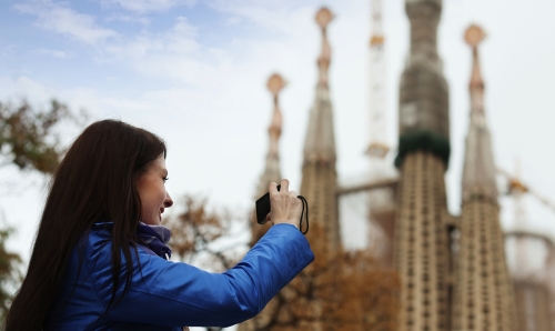 Female tourist   photographing  Sagrada Familia at Barcelona