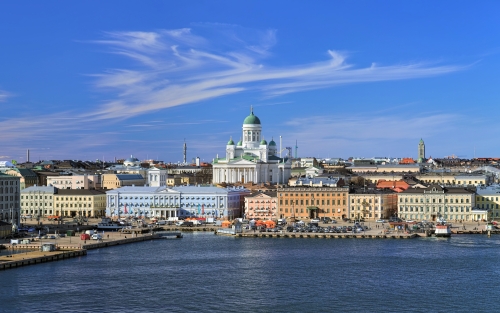 Helsinki, Finland. Scenic cityscape with Helsinki Cathedral, South Harbor, Market Square (Kauppatori) and beautiful cirrus clouds over them in the sunny spring day.