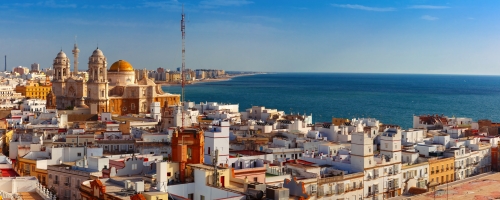 Aerial panoramic view of the old city rooftops and Cathedral de Santa Cruz in the morning from tower Tavira in Cadiz, Andalusia, Spain