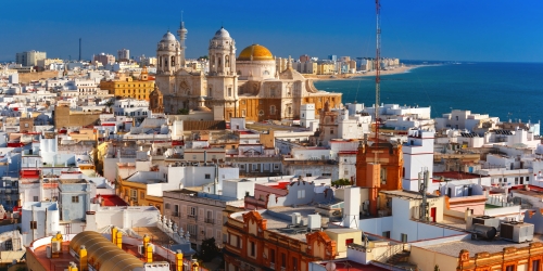 Aerial panoramic view of the old city rooftops and Cathedral de Santa Cruz in the morning from tower Tavira in Cadiz, Andalusia, Spain