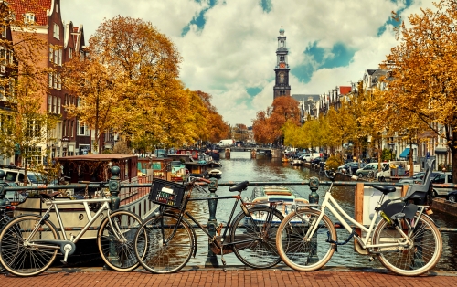 Bike over canal Amsterdam city. Picturesque town landscape