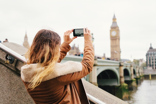 Female tourist taking a photo with mobile phone