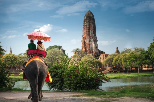 Tourists on an elephant ride tour of the ancient city Ayutaya ,thailand