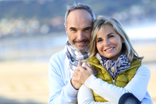 Senior couple sitting by the beach~1