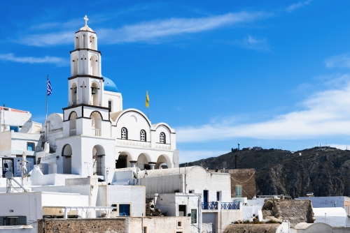 Traditional greek architecture in Pyrgos village, Santorini island, Greece. White cycladic architecture against the blue sky