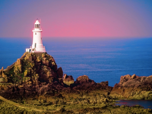 White lighthouse on Jersey Island. Image is toned