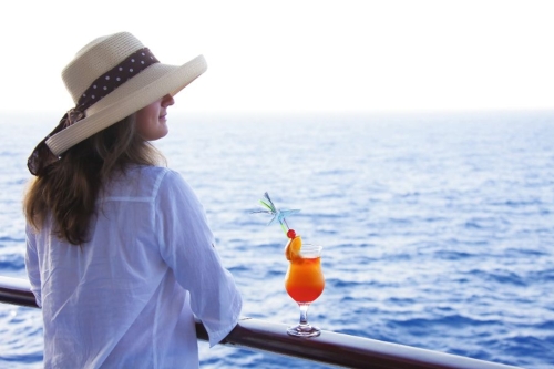 Girl on the deck drinking a cocktail