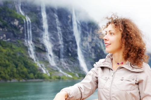 Portrait of woman against Seven Sisters Waterfall