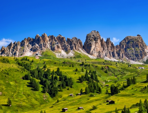 Dolomiten mit grünen Wiesen und Berghütten, Südtirol, Italien